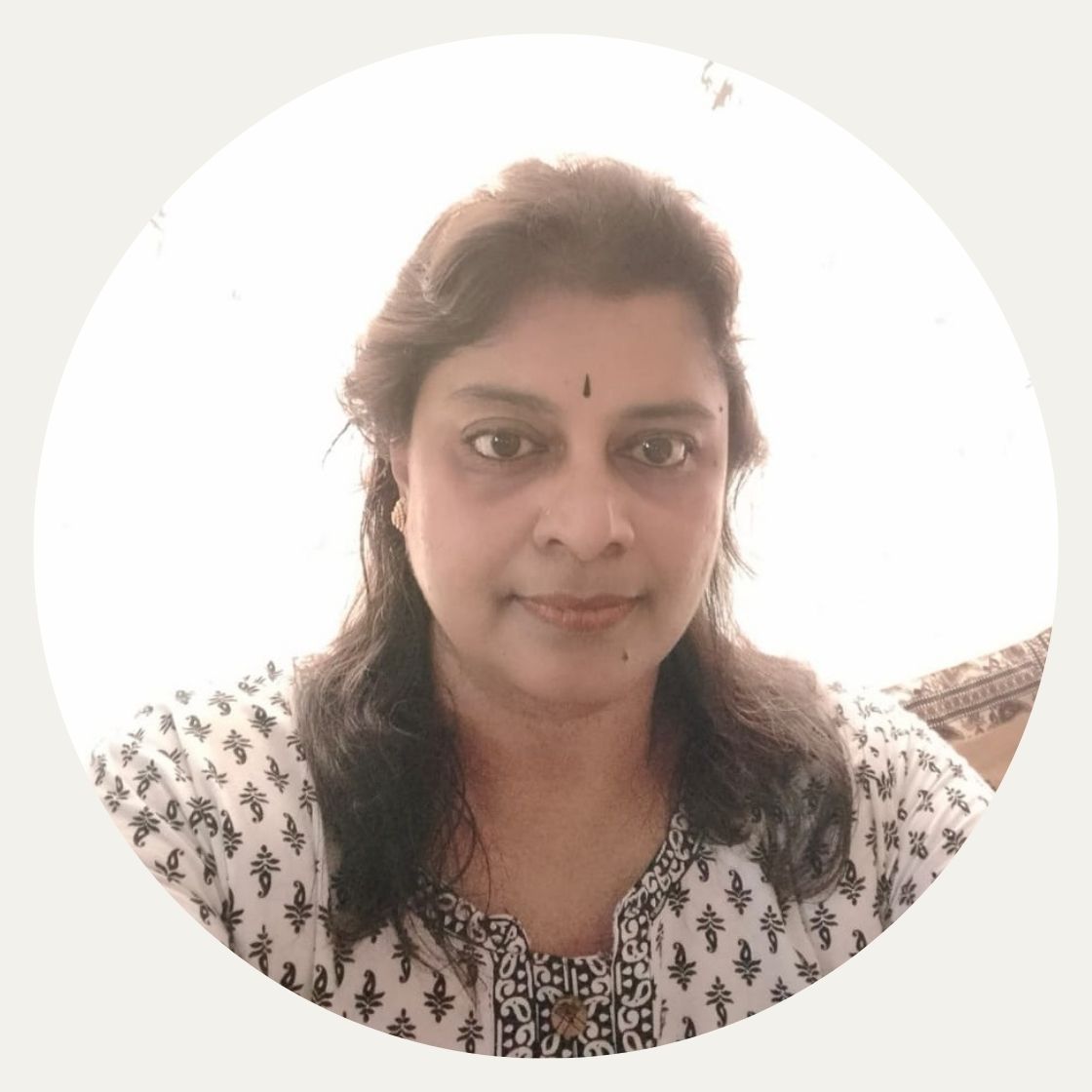 Woman wearing pattern blouse in image