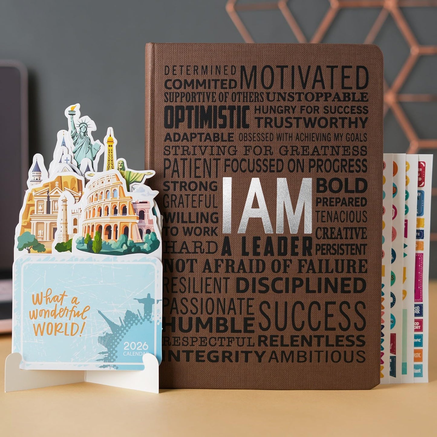 Decorative book with motivational text and a small model of the Colosseum on a table.