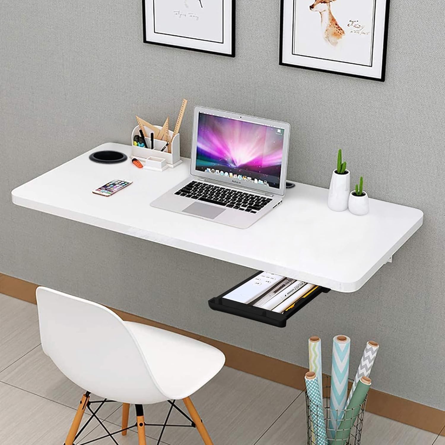 White wall-mounted desk with a laptop, office supplies, and a chair in a room.