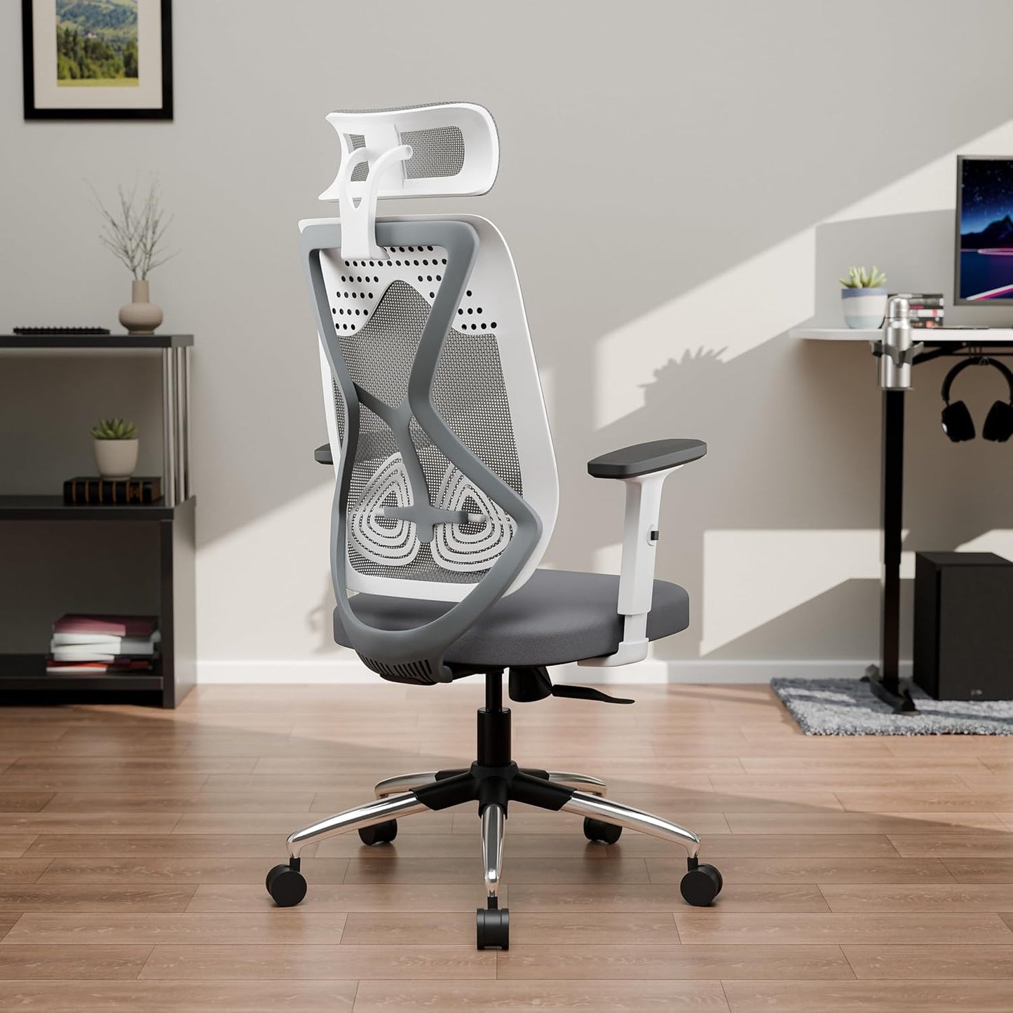 Gray and white office chair in a home office setting with a desk and computer.